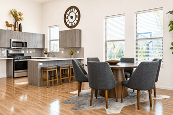 Open concept dining area with gray upholstered chairs